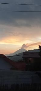 un tramonto con una montagna sullo sfondo di bungalow karohill a Berastagi