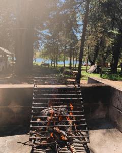 a grill with a fire in a park at Cabaña Clarita La Florida in La Florida +12 photos