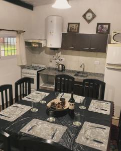 a kitchen with a table with chairs and a counter top at Cabaña Clarita La Florida in La Florida