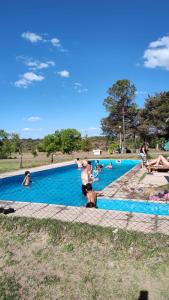 a group of people swimming in a swimming pool at Cabaña Clarita La Florida in La Florida