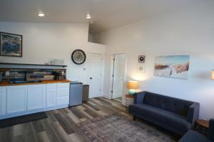 a living room with a couch and a table at Bluff Hideaway - Guest House in Homer