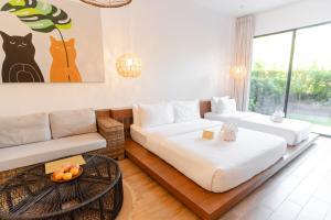 a living room with two beds and a couch at Nacpan Beach Resort in El Nido