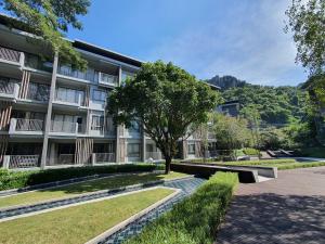 a building with a tree in front of it at Relaxing 2 Bedroom in Khaoyai in Ban Huai Sok Noi