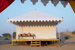 a white tent with a bed in the desert at Desert Stay Camp in Sām