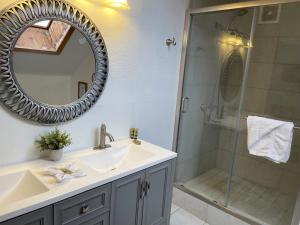 a bathroom with a sink and a shower with a mirror at Snow Bear Lodge in Big Bear Lake