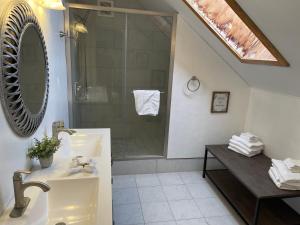 a bathroom with a shower and a sink and a mirror at Snow Bear Lodge in Big Bear Lake