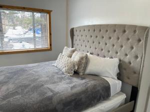 a bedroom with a large bed with a large headboard at Snow Bear Lodge in Big Bear Lake