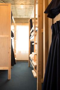 a room filled with wooden bunk beds with a window at Wharf Inn in Yokohama
