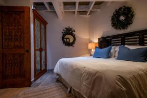 a bedroom with a large bed with blue pillows at Sollano 34 in San Miguel de Allende