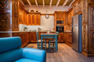 a kitchen with wooden cabinets and a blue table at Sollano 34 in San Miguel de Allende