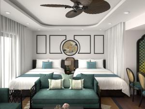 a bedroom with two beds and a couch at Quy Nhon Pearl - FLC Sea Tower in Quy Nhon