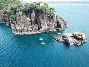 an aerial view of a rocky island in the water at Hostel Lali beach villa in Trincomalee