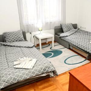 a living room with two beds and a couch at ASPERA Apartments in Kumanovo