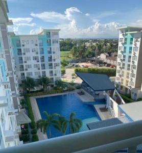 a view of a swimming pool from a balcony of a building at Relax & feel cozy here @ Seawind in Davao City