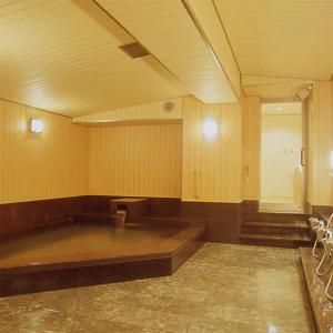 a large empty room with a large empty table at Kamogawakan in Kyoto