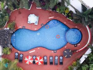 an overhead view of a swimming pool with a tennis racket at Silver Sands Sunshine - Angaara in Candolim