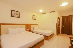 Postel nebo postele na pokoji v ubytování Song Anh 3 Hotel