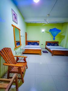 Letto o letti in una camera di Dinesh Safari Homestay