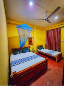 Postel nebo postele na pokoji v ubytování Dinesh Safari Homestay