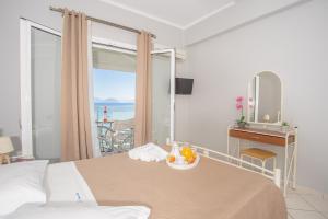 a bedroom with a bed with a table and a mirror at Romanza Studios in Vasiliki