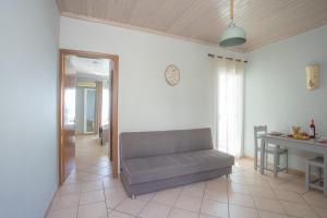 a living room with a couch and a table at Romanza Studios in Vasiliki