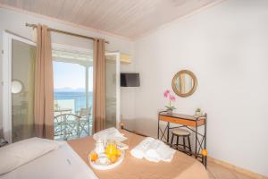 a hotel room with a bed and a table with food on it at Romanza Studios in Vasiliki