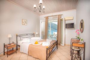 a bedroom with a bed and a table and chairs at Romanza Studios in Vasiliki