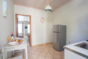 a kitchen with a stainless steel refrigerator and a table at Romanza Studios in Vasiliki