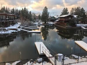 a marina covered in snow with houses and boats at Tahoe Waterfront Condo with Boat Dock in South Lake Tahoe