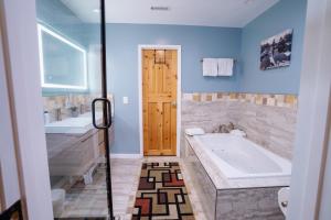a bathroom with a tub and a sink and a bath tub at Tahoe Waterfront Condo with Boat Dock in South Lake Tahoe