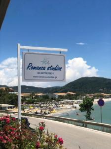 a sign for the rivanica village with a beach at Romanza Studios in Vasiliki
