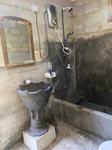 a bathroom with a sink and a mirror and a shower at OM Homestay in Bentota