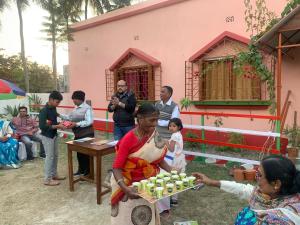 a woman standing in front of a table filled with cupcakes at Sarkar Villa Homestay in Kolkata