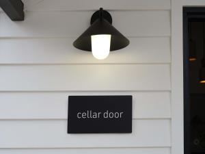 a black light hanging from a wall with a sign at Shawwood Estate in Buckaroo