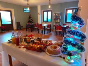 a living room with a table with food and a christmas tree at Affittacamere Ellera Verde in Villetta Barrea