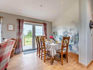 a dining room with a table and chairs at 3 Bed in Livingston 91829 in Forth