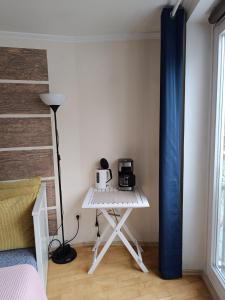 a room with a table with a microwave and a bed at Apartment am Bach in Augsburg
