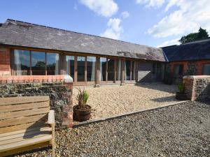 a brick house with a bench in front of it at 3 bed in Barnstaple 09092 in Umberleigh Bridge