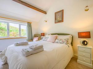 a bedroom with a large white bed with towels on it at 4 Bed in Routenbeck SZ405 in Bassenthwaite Lake