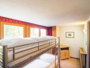 a bedroom with a bunk bed and a window at Private Holiday Home in Mariapfarr with Lovely Garden in Mariapfarr
