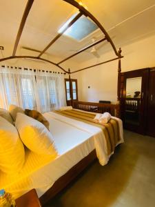 a bedroom with a large bed in a room at Happy Valley Residence Unawatuna in Galle