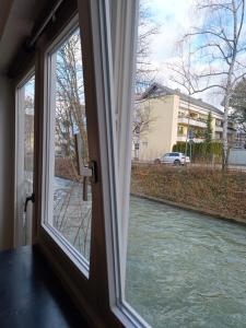 a window with a view of a river at Apartment am Bach in Augsburg