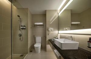 a bathroom with a sink and a toilet and a shower at AC Hotel by Marriott Penang in Bayan Lepas