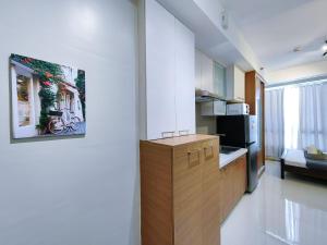 a kitchen with white walls and a wooden counter top at Condotel at Sunshine100 Mandaluyong City near EDSA in Manila