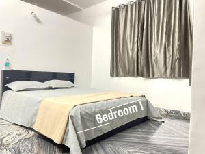 a bedroom with a bed with a bed frame and a window at Sai Homestay Goa - Margao in Madgaon