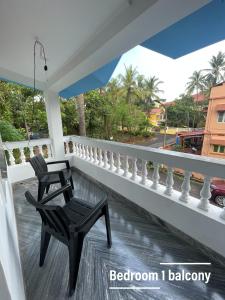 a chair on a balcony with a view of a street at Sai Homestay Goa - Margao in Madgaon