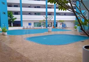 an empty swimming pool in front of a building at Mutiara Melaka Beach Resort - Islamic Compliance Only in Tangga Batu