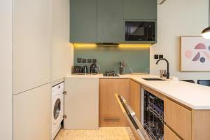 a kitchen with a washer and a dishwasher at FAM Living - Upside Living - WFH Friendly-Business Bay in Dubai