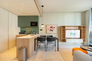 a kitchen with a table and chairs in a room at FAM Living - Upside Living - WFH Friendly-Business Bay in Dubai