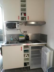 a small kitchen with a sink and a stove at Maisonnette avec terrasse Marseille 9ème in Marseille